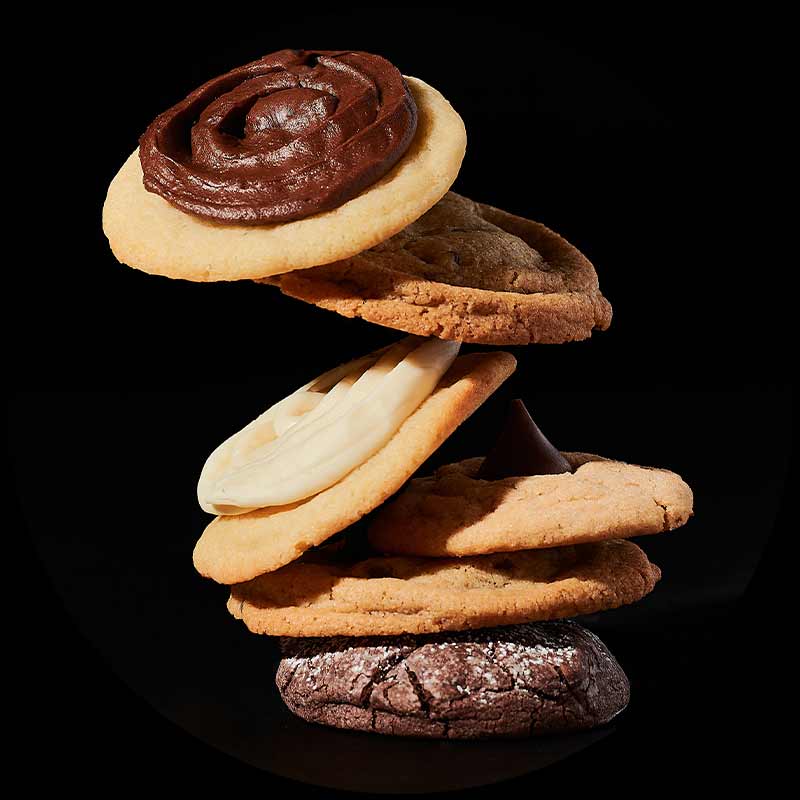 Six different flavored cookies stacked in various positions.